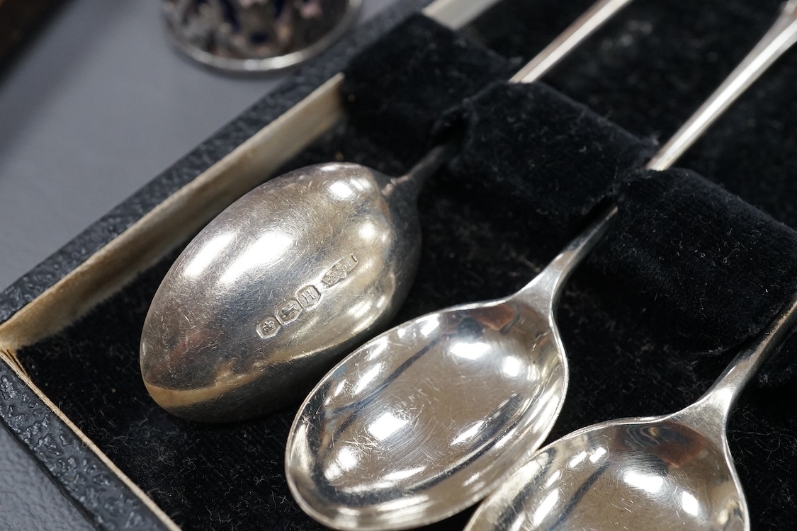 Four assorted silver napkin rings, two cased sets of six silver spoons, four silver condiments including a pair, a small group of sundry flatware, a silver wine label and a plated napkin ring.